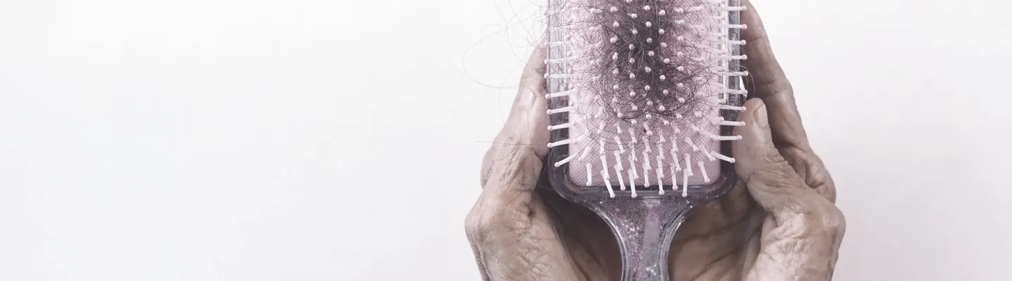 a person holding a hair brush in their hands