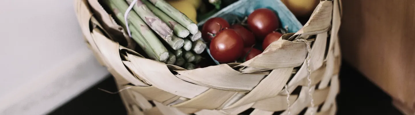bunch of assorted produce in brown wicker basket